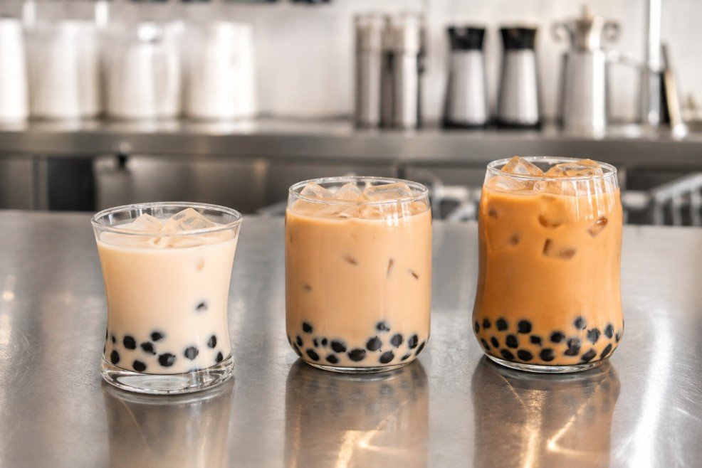 Different boba sweetness and ice levels shown in tasting cups