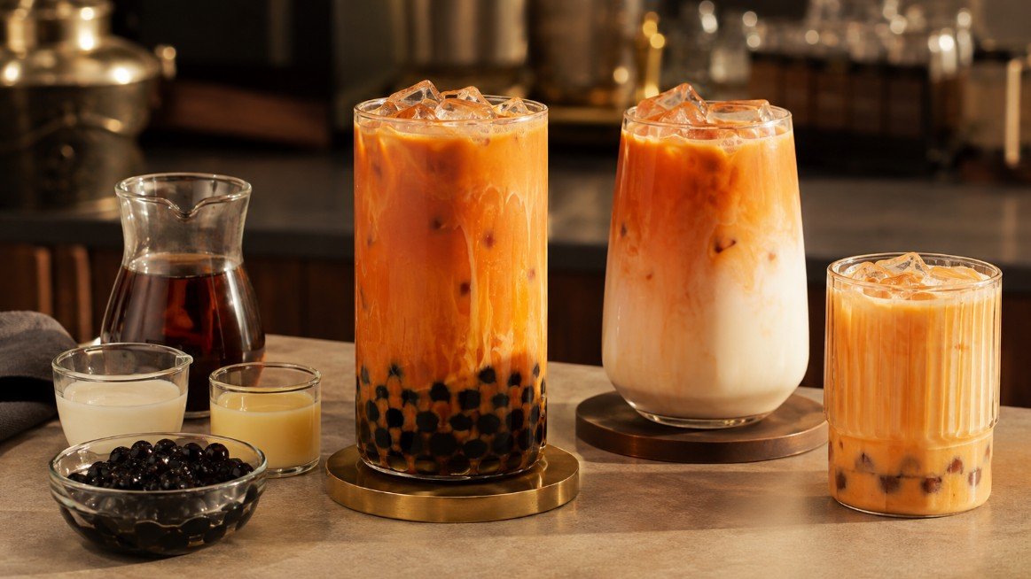 Thai tea boba with creamy orange Thai milk tea, black tapioca pearls and layered Thai tea variations.